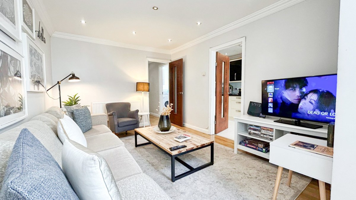 Living room with a grey sofa, coffee table and television